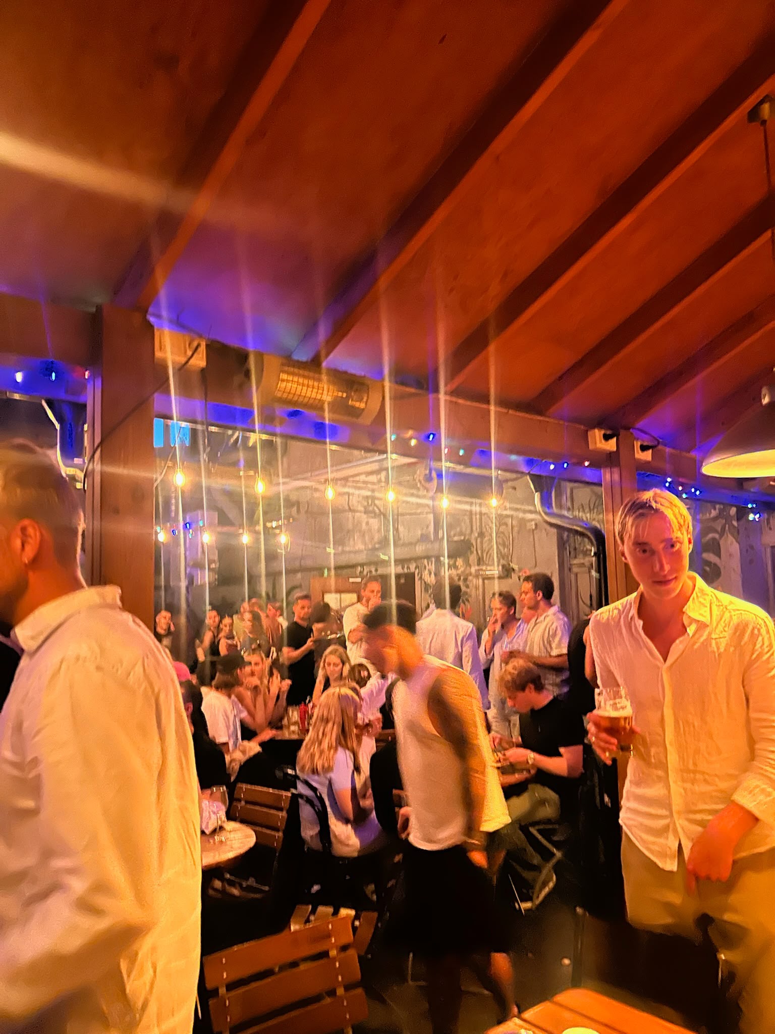 A lively Oslo bar filled with guests
