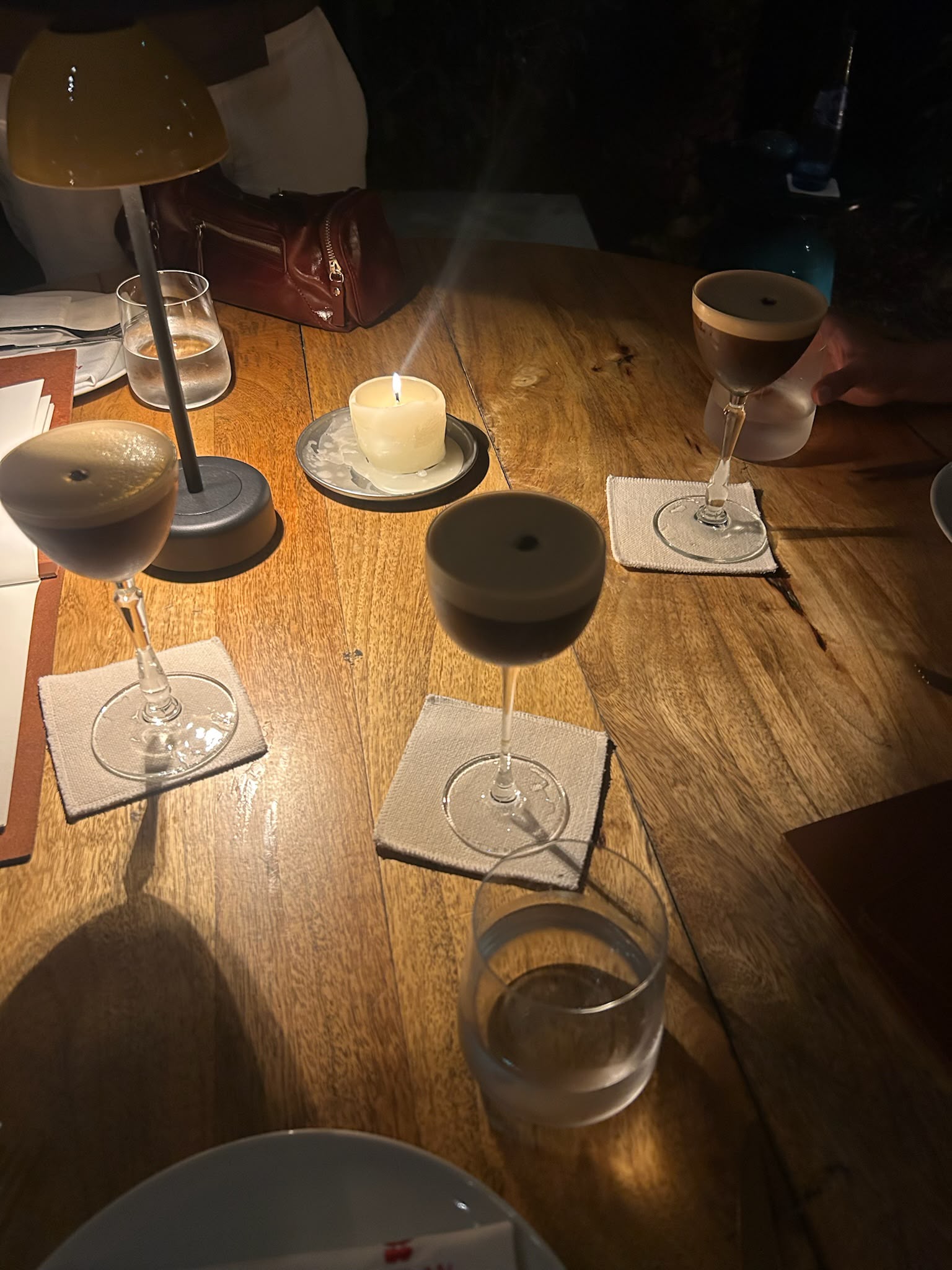 Cocktails arranged around a candlelit table