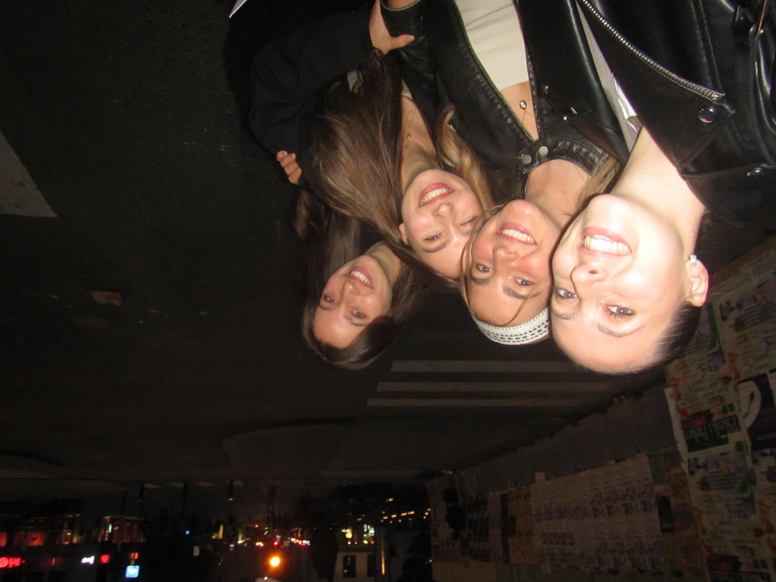 Four friends posing together on a night out