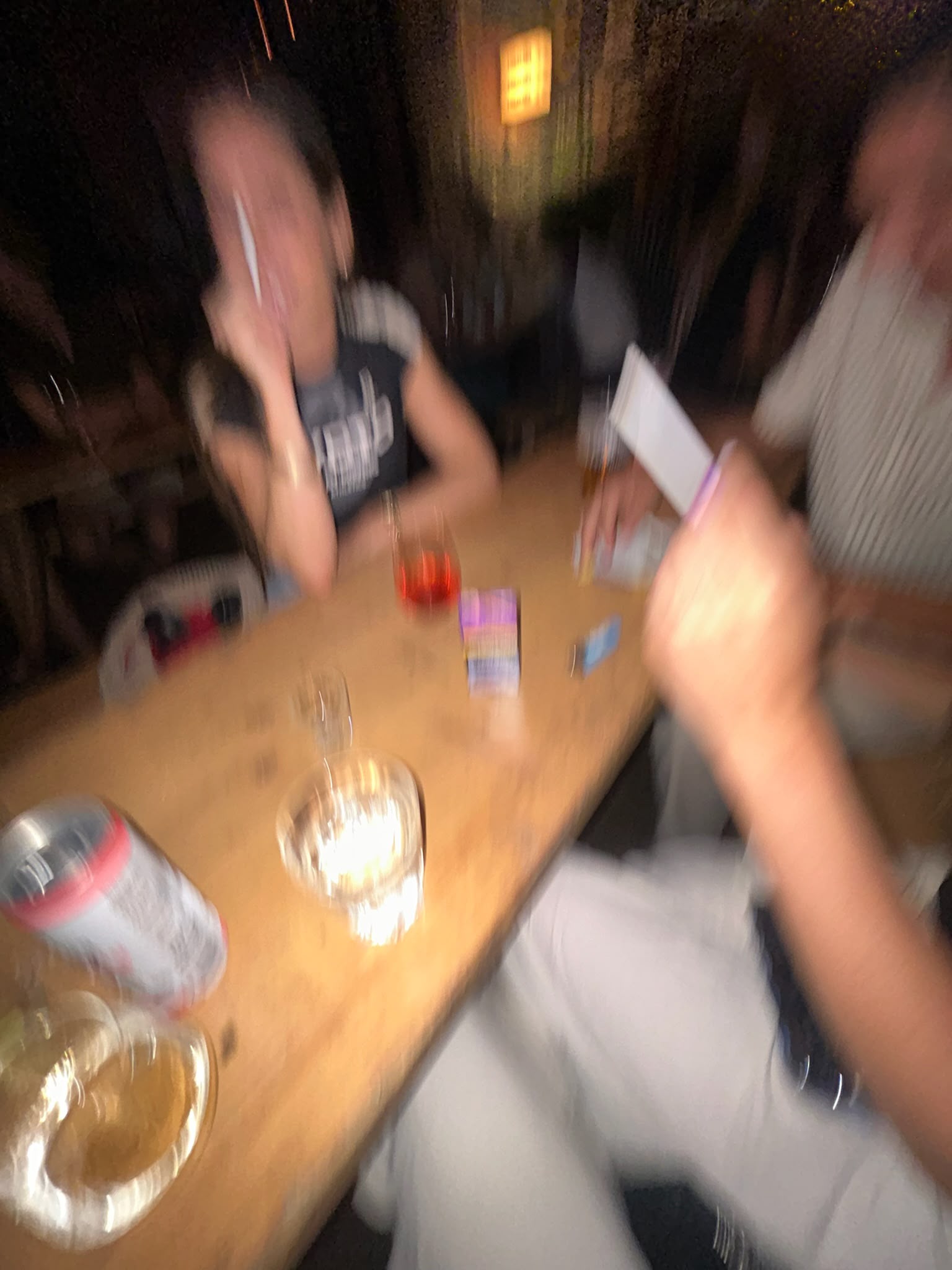 Friends sharing drinks around a bar table