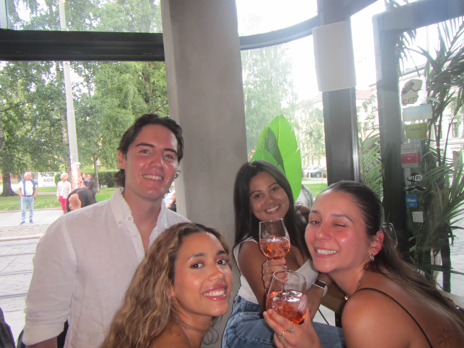Four friends leaning in for a celebratory toast